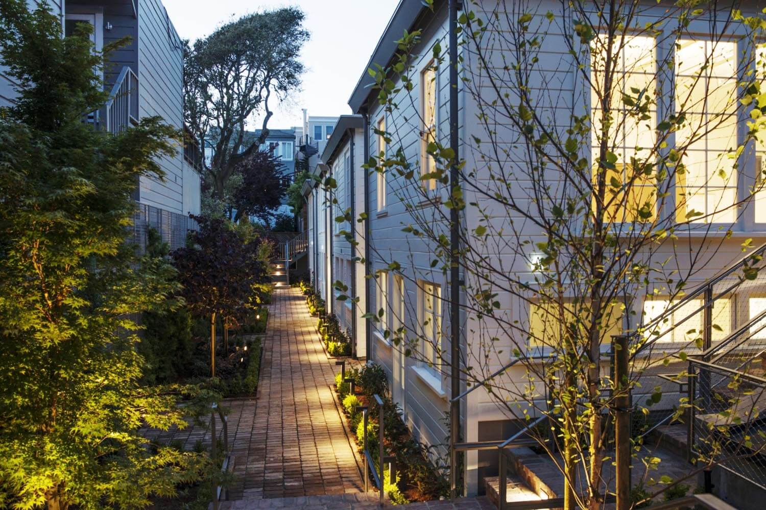 Exterior view of Filbert Cottages in San Francisco, CA showing brick pathway