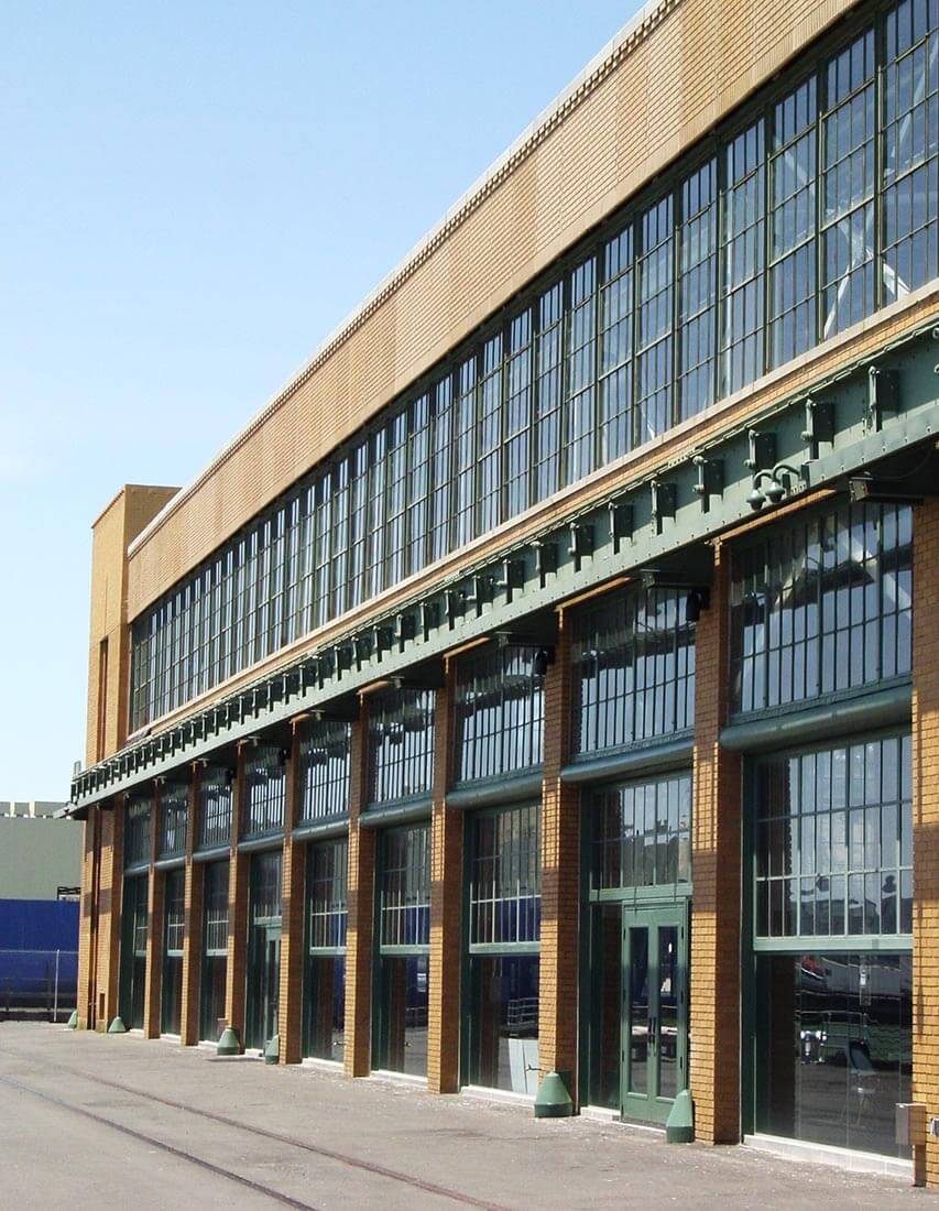 Exterior view of Ford Assembly Building, Richmond, CA showing tall brick and glass facade
